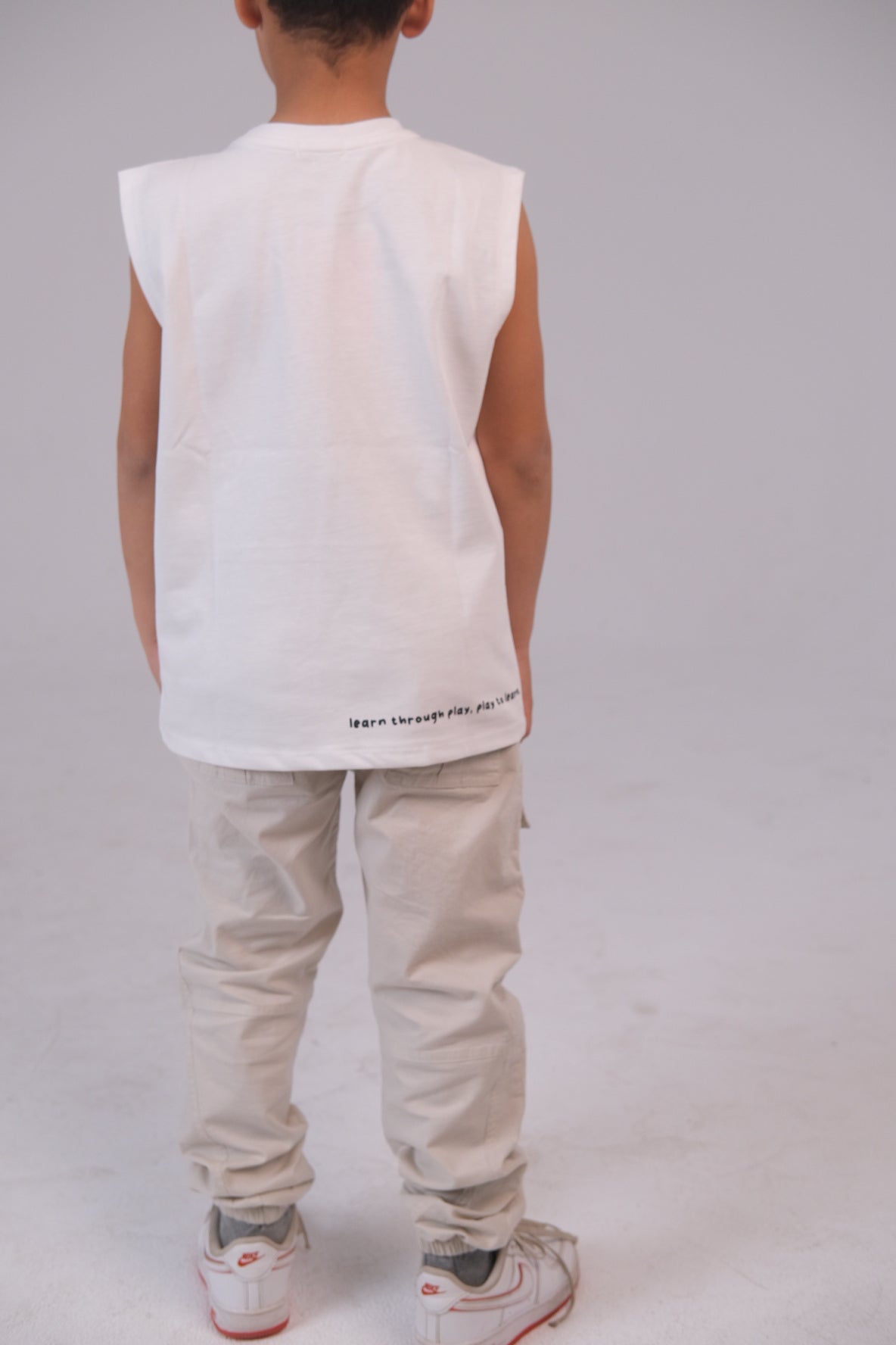 Unisex Sleeveless Cotton T-Shirt – White "Learn Through Play" Design